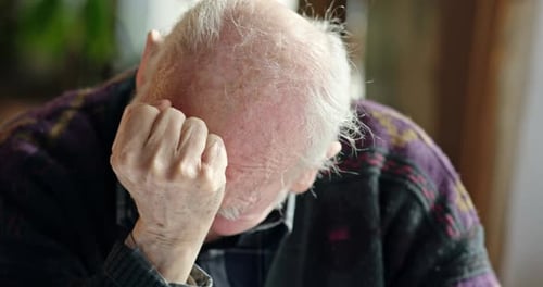 Senior Man Holding Head, Then Smiling Brightly