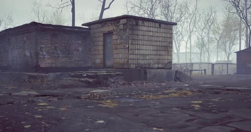 Mysterious Abandoned Building Shrouded in Fog During Early Morning Light