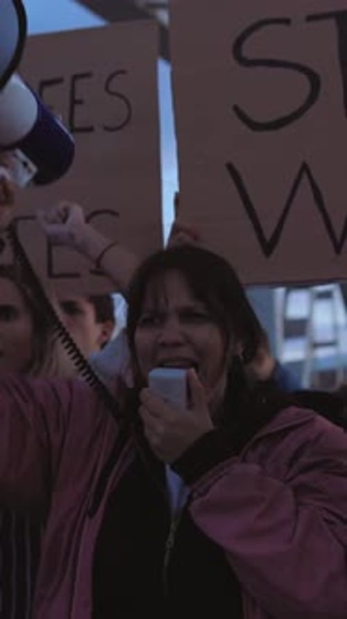 Woman speaks into megaphone at protest demonstration