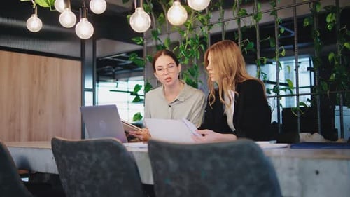 Two Women Working Together in Modern Office