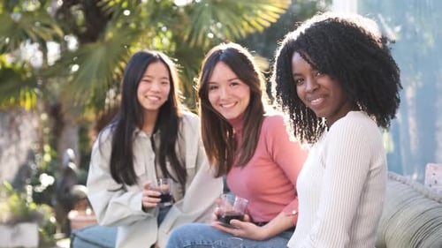 Diverse Girlfriends Drinking Beverages on Terrace