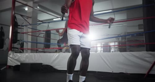 Legs, man and skipping with rope at gym for wrestling match, workout and fitness competition