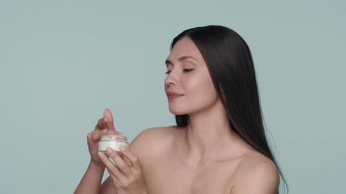 Cream for Skin Care A Seminude Woman Dips Her Fingers Into a Jar of White Cream Woman with Cream in