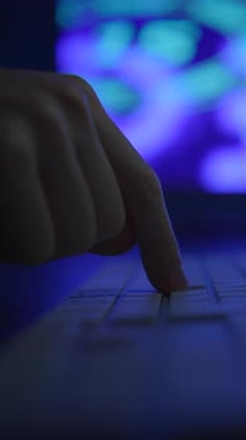 Hand Typing on Futuristic Laptop Keyboard