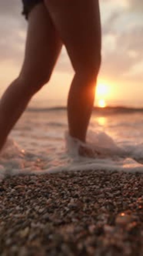 Woman Walking Barefoot on Beach at Sunset