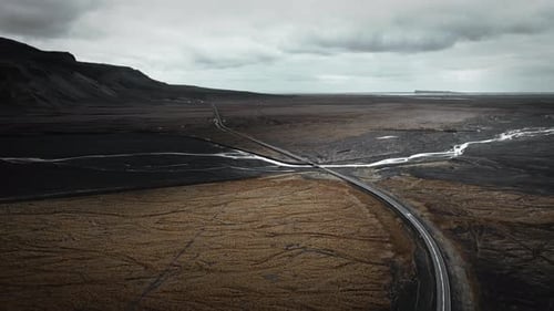 Moody Aerial View of Winding Road Through Volcanic Plateau Landscape