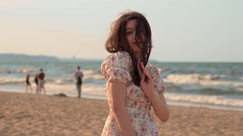 Charming Young Woman Looking at Camera at Sea Beach Smiling and Flirting at Sunset Slow Motion