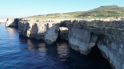 Aerial drone view of cliffs in Malta and the Mediterranean Sea