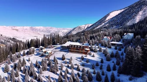Snowy Mountain Hotel Surrounded By Pine Trees in Winter