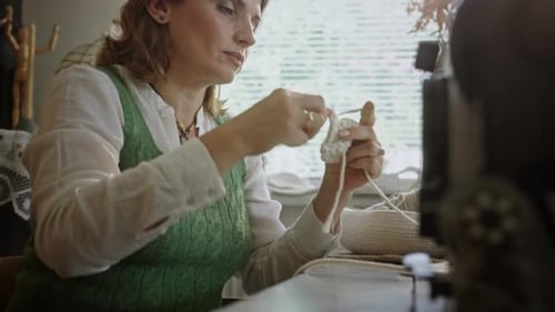 Craftswoman Crocheting in Home Studio