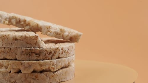 Rotating Rice waffles on a beige background.
