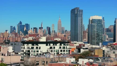 Aerial View of Rooftops of Low Residential Buildings in Brooklyn with Modern Skyscrapers of Midtown
