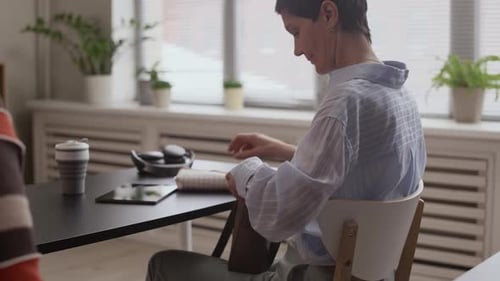 Teacher Explains Technology to Adults in Classroom