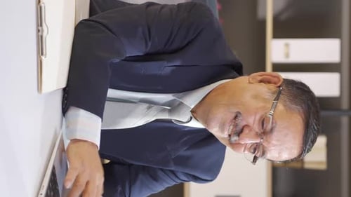 Man Celebrates Success at Desk in Office Setting