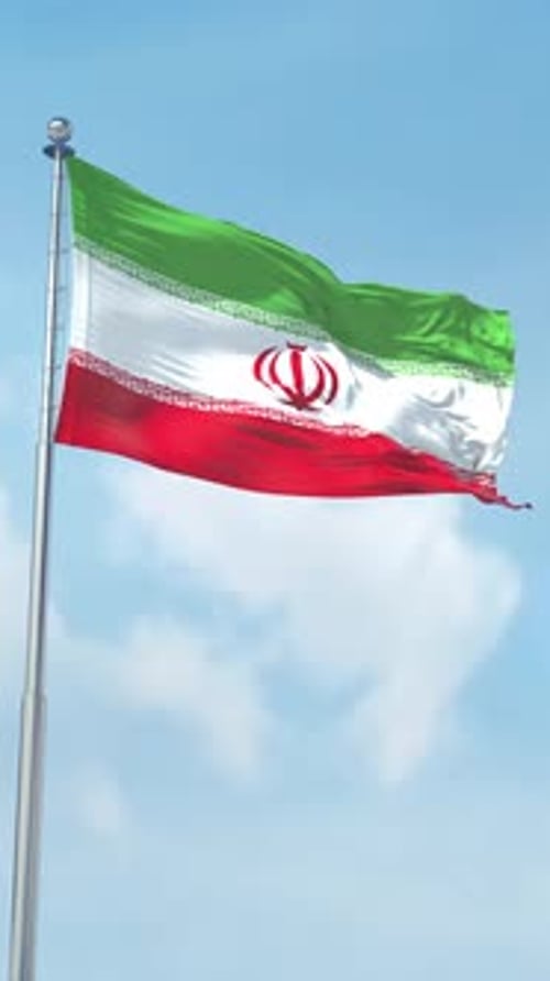 Waving Iranian Flag Against Blue Sky