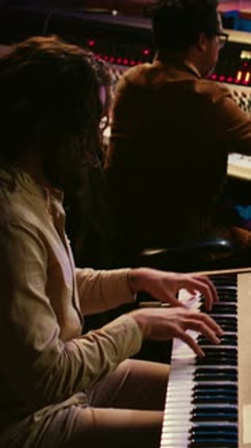Man Plays Keyboard in Warm Recording Studio