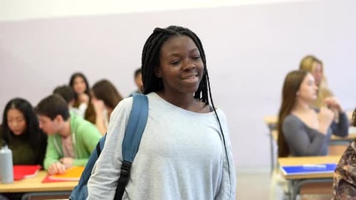 Teen Student Smiles in a Busy Classroom