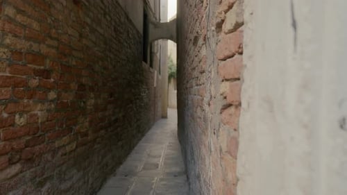 Narrow European Alleyway Through Old Brick Buildings