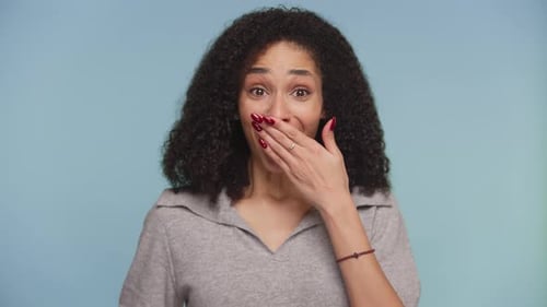 Excited Woman Reacting to Surprising Good News on Blue Background
