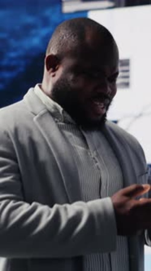 Professional Man Using Smartphone at Workplace Analyzing Data