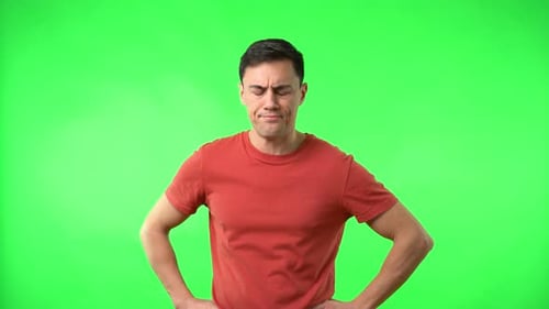 Skeptical Man with Thumbs Down on Green Screen