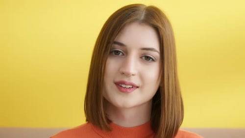 Close Up of Young Woman in Front of Yellow