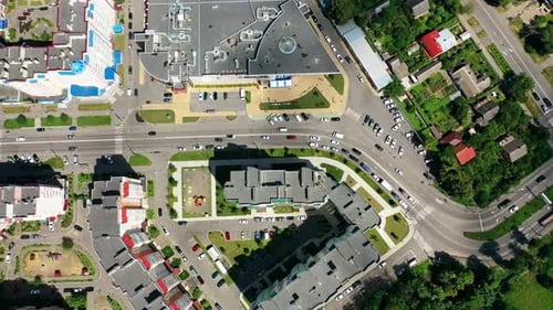 Modern cityscape. Residential streets and cars between apartment building rooftops.