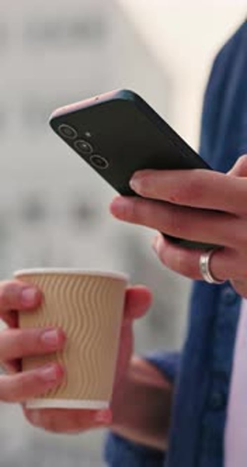 Person, hands and coffee and phone in city for website, social media update or check text message