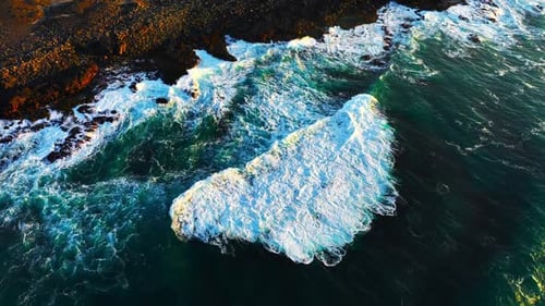 Coast of the Atlantic Ocean in Windy Weather Large Waves Crashing on Sharp Black Basalt Rocks