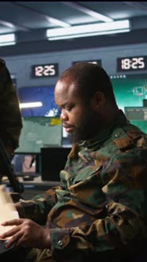 Military Personnel Monitoring Screens in an Operations Center