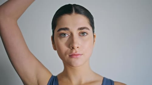 Young Woman Stretching Neck Muscles in Studio