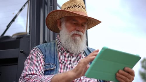 Man With Beard Using Tablet Device Outdoors