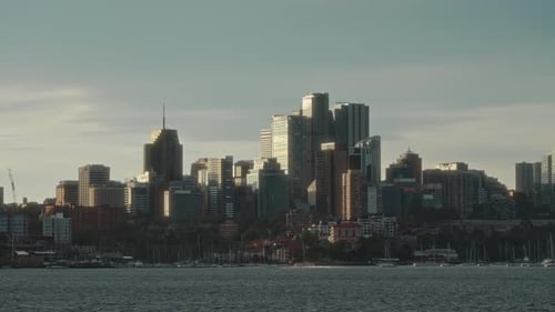 Radiant Sunset Transforms City Skyline Into Vibrant Spectacle With Lively Waterfront Ambiance