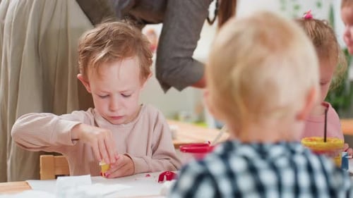 Little Boy Opening Paint Container During Art Class