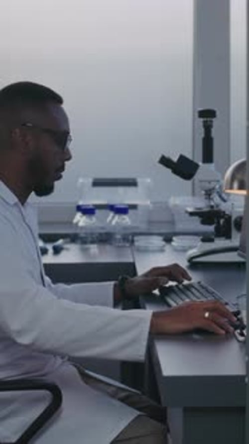 Scientist Working on Computer in Medical Lab