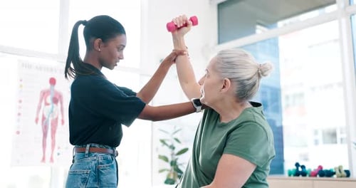 Young Adult Assists Senior Woman with Physical Therapy
