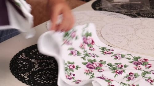 The Woman Makes A Review Of The Purchase. Lays Terry Towels On The Table. Close Up, From The Side.