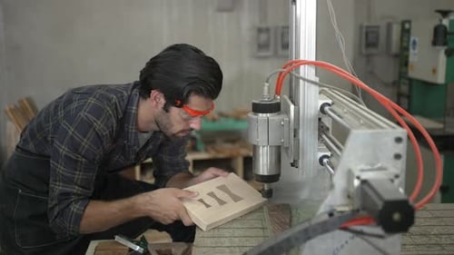 Carpenter is working at workshop.