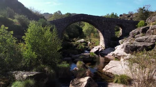 Flying Over Ancient Stone Bridge Over Beautiful River. Amazing Nature Landscape