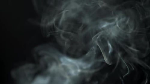 White Smoke Billowing Against Black Background
