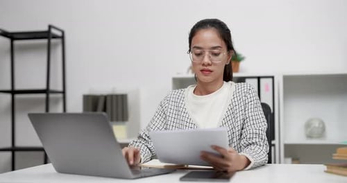 Young Woman Works at Laptop in Bright Modern Office