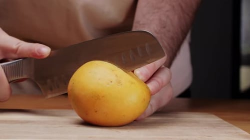 Man Cutting Fresh Mango with Sharp Knife