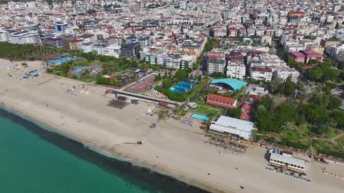 Aerial Video of a Stunning Cityscape With a Wide Beach Turquoise Sea and a Vibrant Skyline Under a