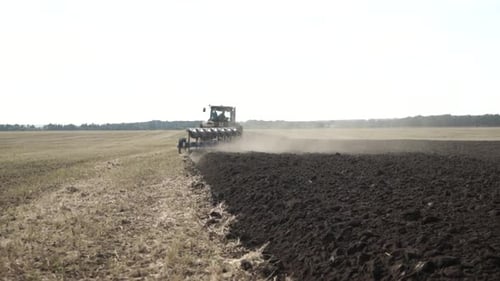 Tractors plowing the field in Ukraine