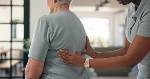 Physiotherapy, back massage and chiropractor with senior woman in office for injury rehabilitation