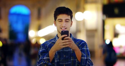 Man look at night in city. Milan italy Handsome young business man using telephone smiling happy