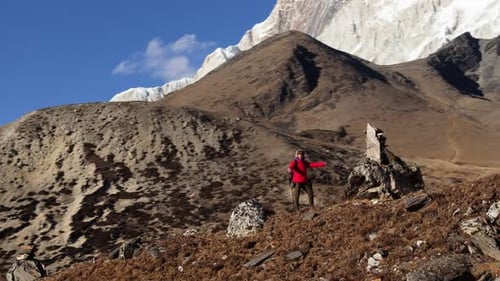 Hiker in Red Jacket Trekking Through the Majestic Mountains of Nepal Capturing the Beauty of the