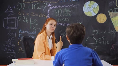 Teacher Helping Student with Math Problems