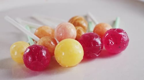 Colorful Ball Lollipops on a White Surface