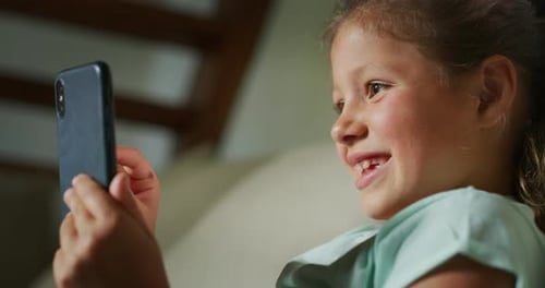 Happy Child Using Mobile Phone Close Up Indoors